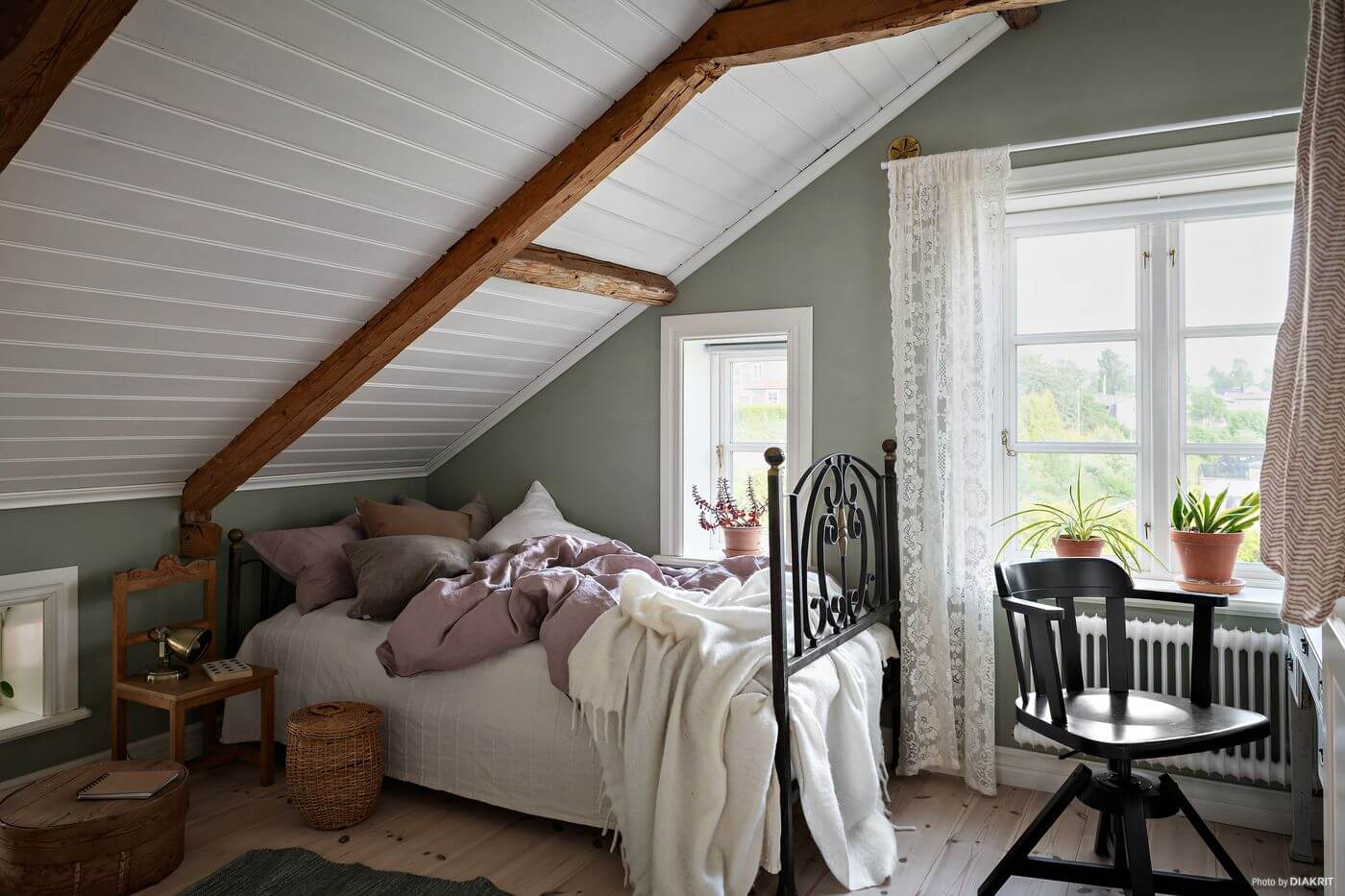 A Charming Swedish Villa Filled with Wallpaper 17 bedroom-sloped-ceiling-wooden-beams-gray-green-walls-nordroom