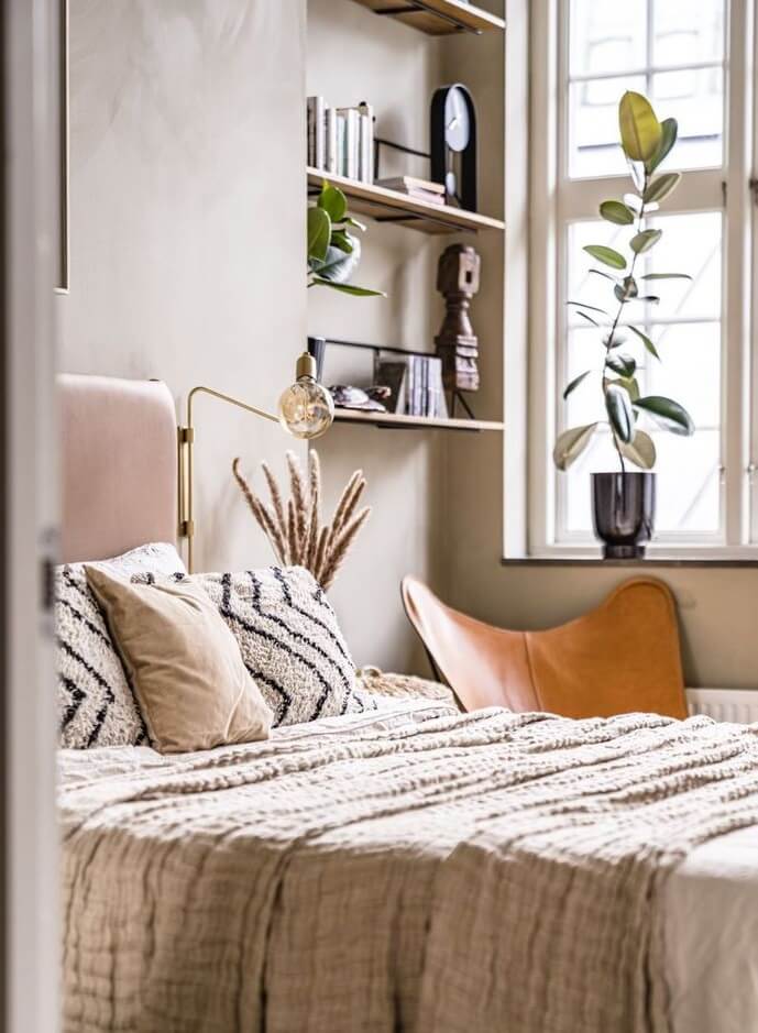 A Historic Factory Transformed Into A Stylish Home 22 beige-bedroom-leather-headboard-shelves-nordroom