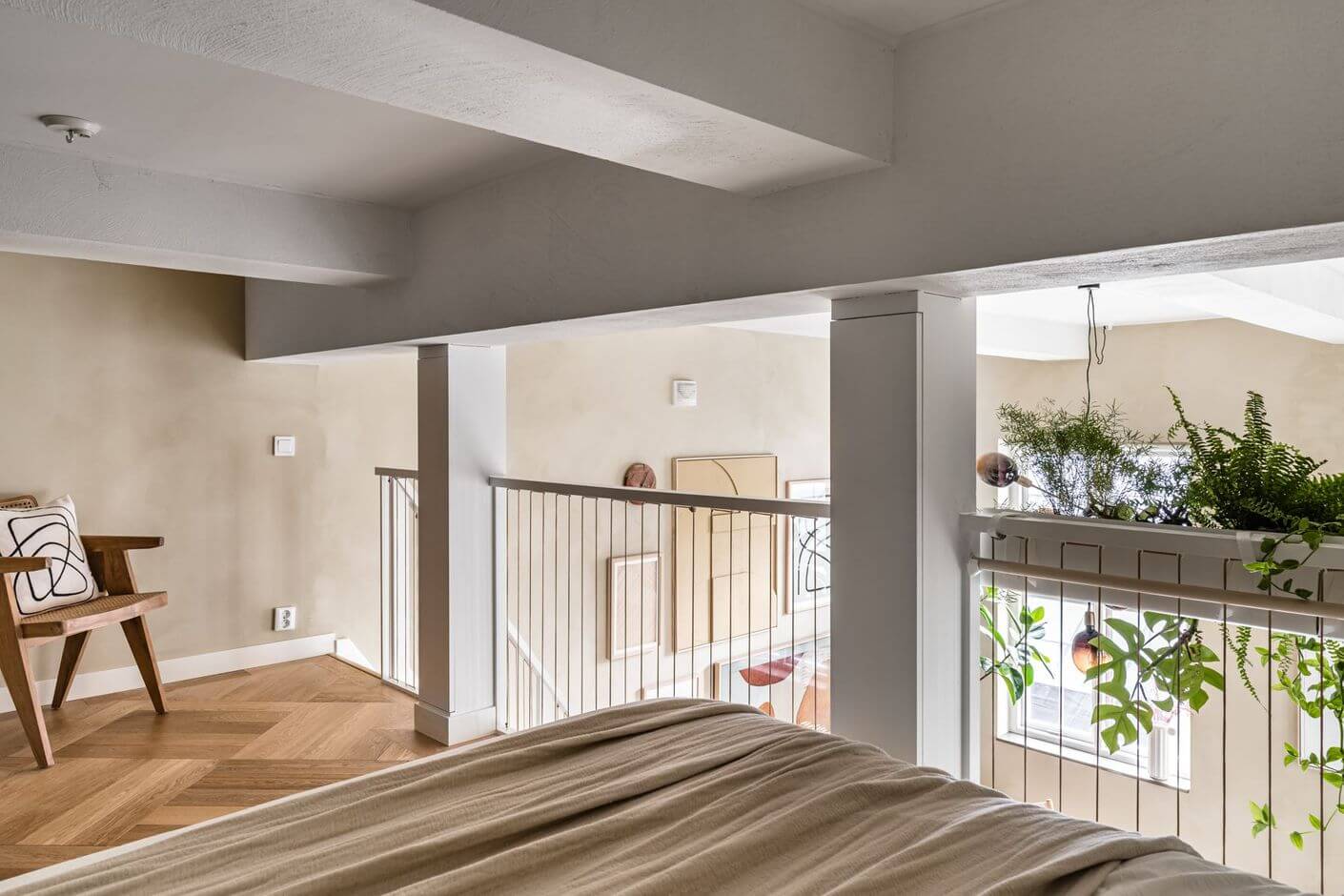 A Historic Factory Transformed Into A Stylish Home 18 beige-loft-bedroom-wood-floor-plants-nordroom