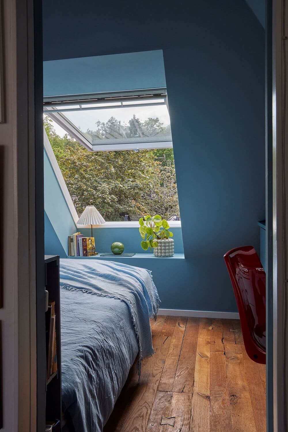 A Split-Level Attic Apartment with Blue Bedroom 11 blue-attic-bedroom-large-window-wooden-floor-nordroom