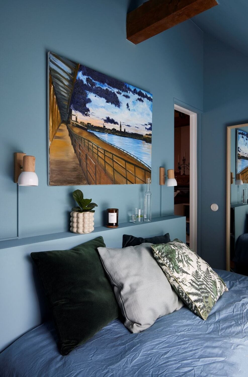 A Split-Level Attic Apartment with Blue Bedroom 14 blue-attic-bedroom-storage-headboard-nordroom