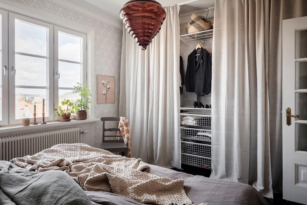 A Swedish Maisonette with Warm Pink Living Room 14 closet-behind-curtain-bedroom-nordroom