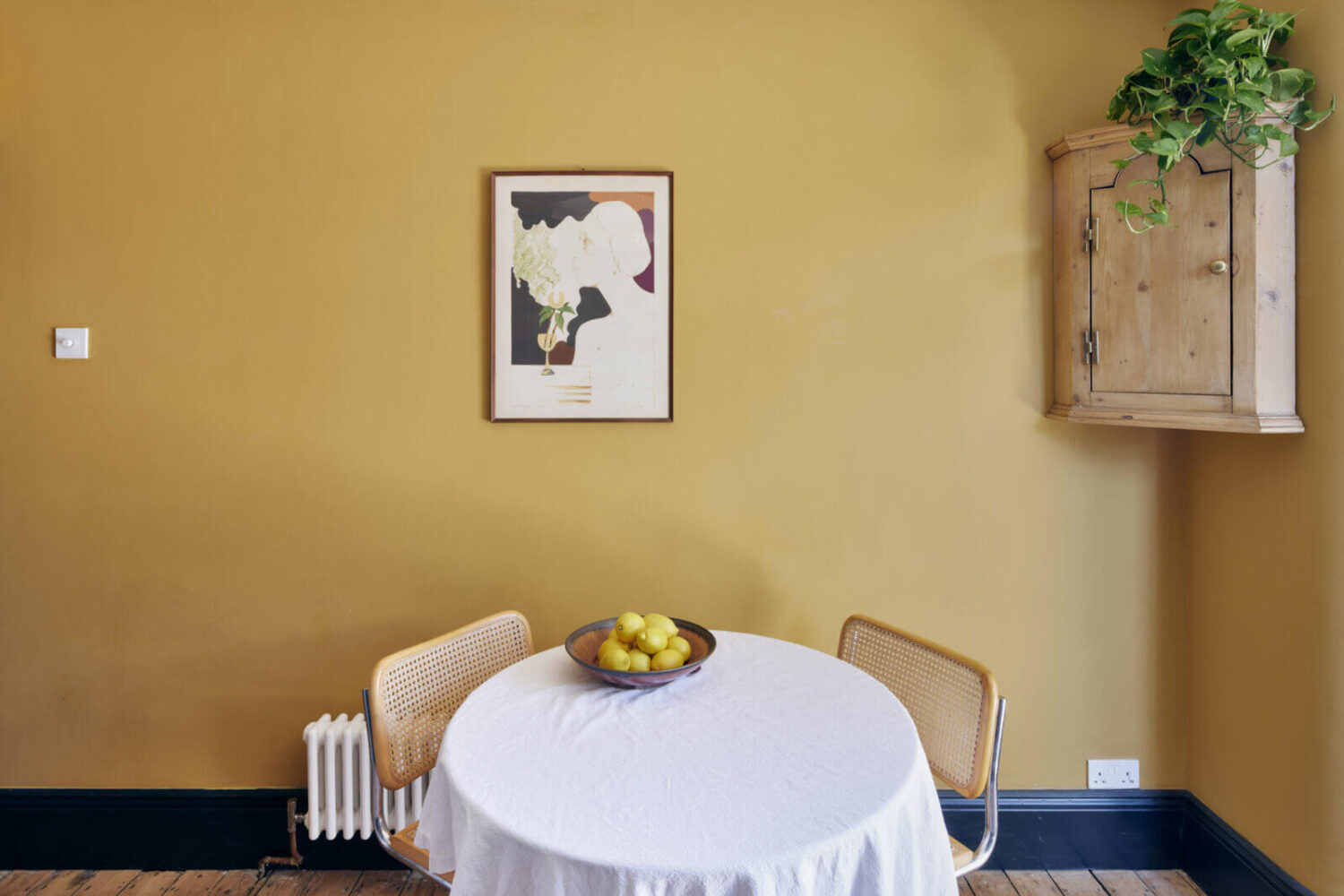 A One-Bedroom Apartment with Colorful Rooms 7 farrow-ball-india-yellow-wall-color-round-dinng-table-nordroom