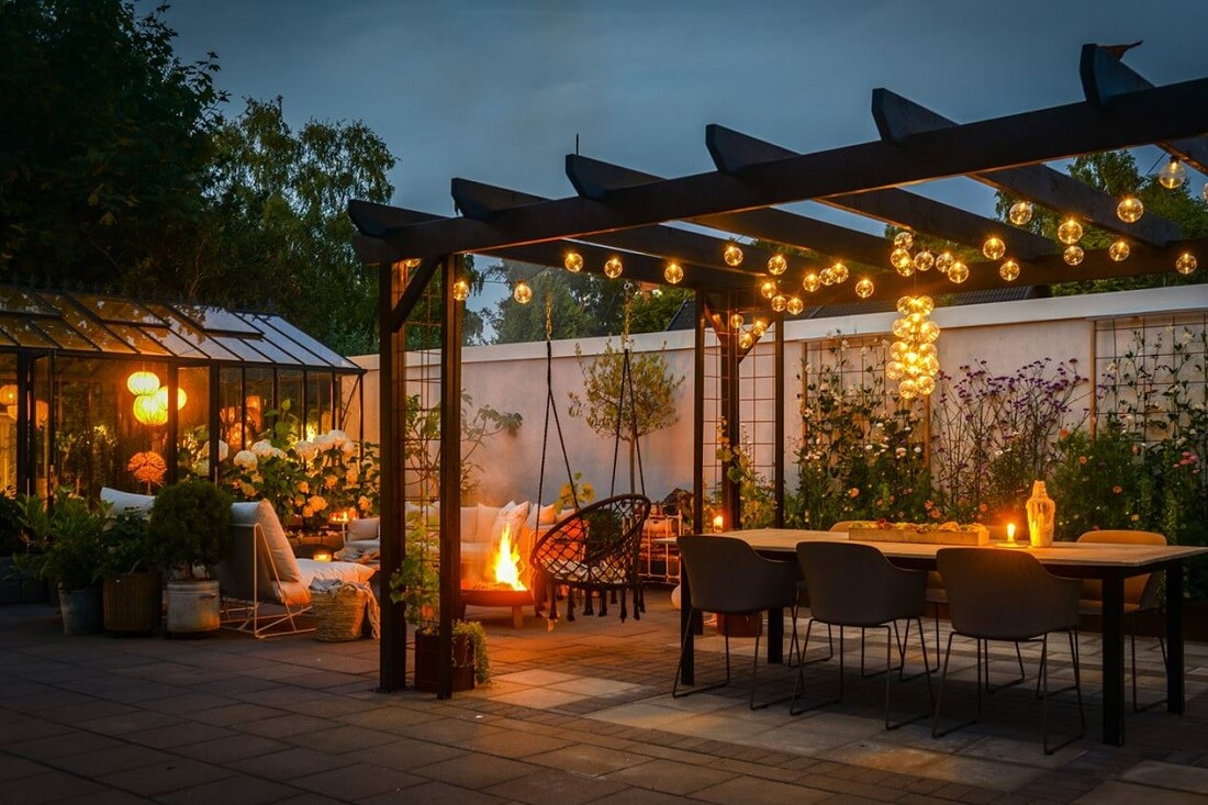 A Swedish 1930s Villa Decorated in Gray and Green Tones 27 garden-at-night-dining-space-seating-nordroom