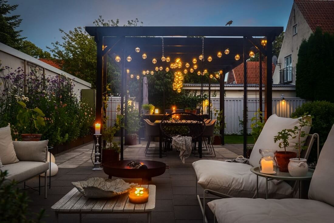 A Swedish 1930s Villa Decorated in Gray and Green Tones 26 garden-at-night-winter-garden-seating-nordroom