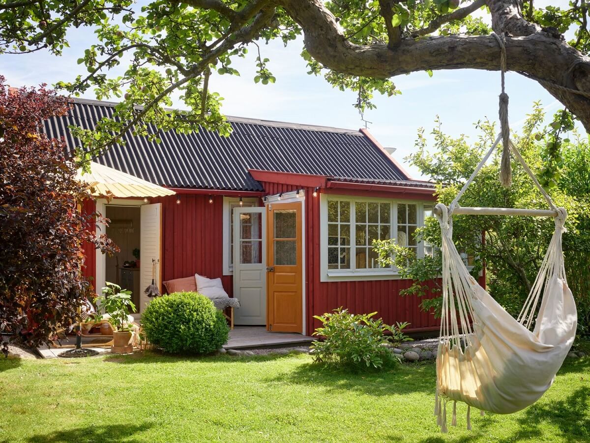 A Cozy Renovated Cottage on a Swedish Allotment 20 garden-hanging-chair-red-cottage-sweden-nordroom