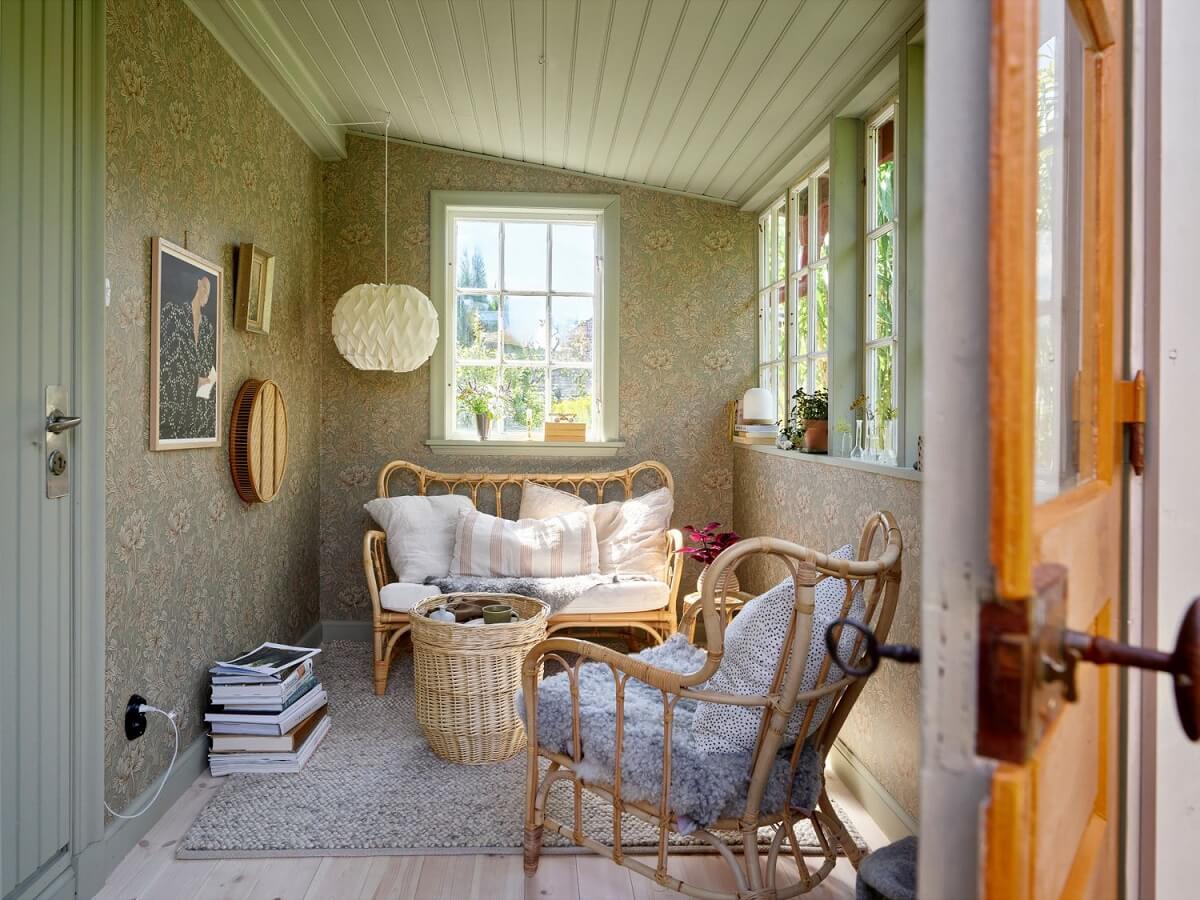 A Cozy Renovated Cottage on a Swedish Allotment 14 garden-room-swedish-summerhouse-rattan-furniture-wallpaper-nordroom