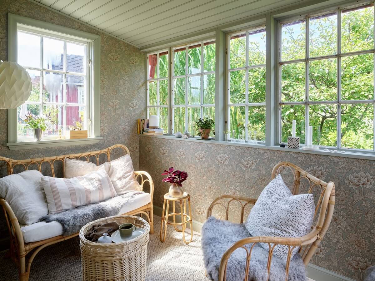 A Cozy Renovated Cottage on a Swedish Allotment 15 garden-room-wallpaper-rattan-furniture-nordroom