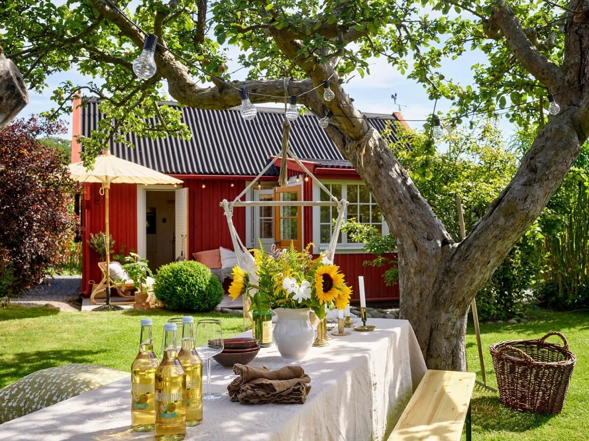 Best of 2022: Outdoor Spaces 4 garden-tree-dining-table-hanging-chair-nordroom