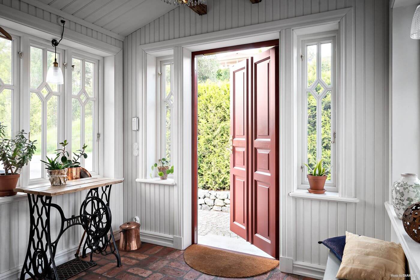 A Charming Swedish Villa Filled with Wallpaper 21 hallway-red-wooden-door-swedish-country-house-nordroom