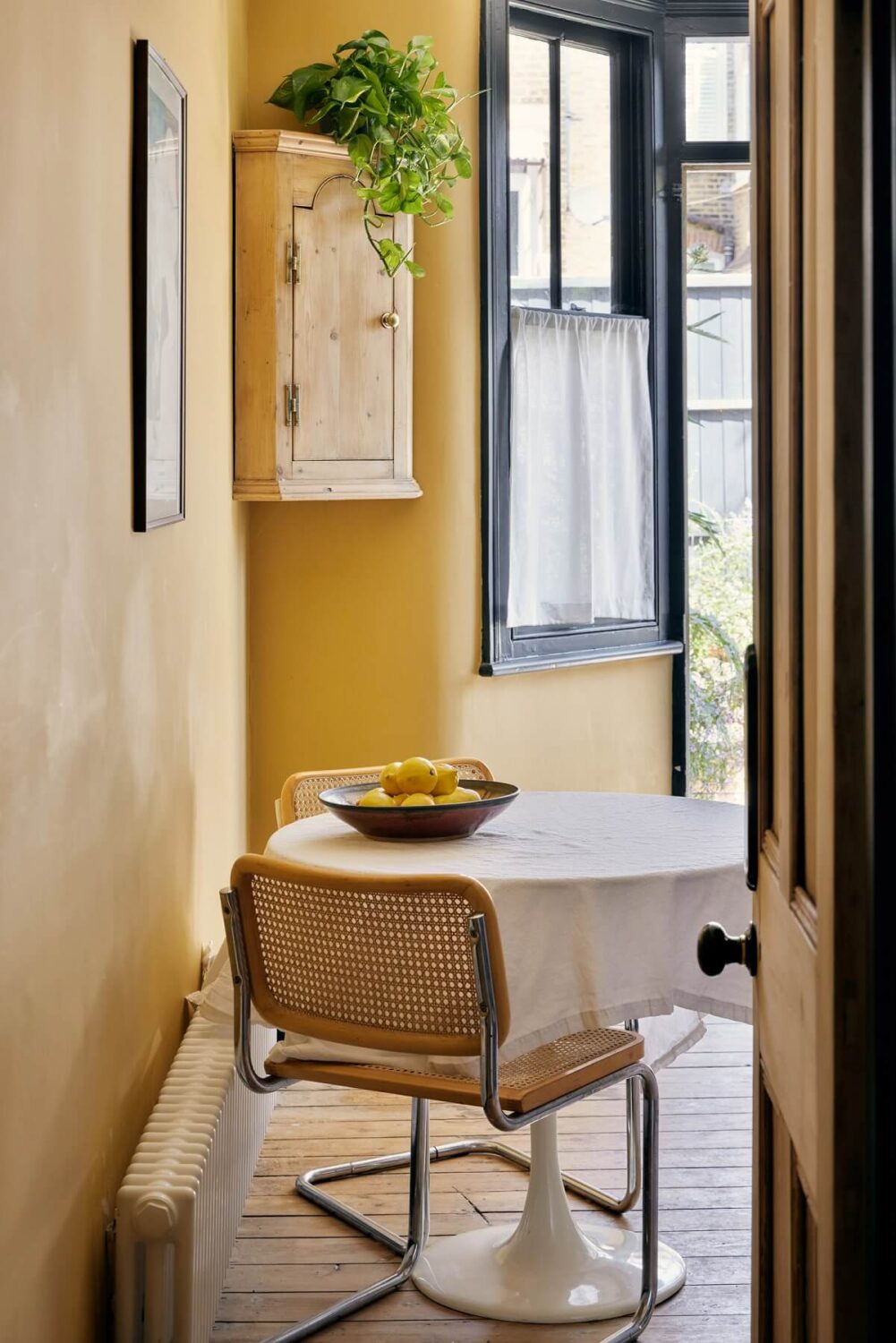 A One-Bedroom Apartment with Colorful Rooms 6 kitchen-dining-table-india-yellow-farrow-ball-nordroom