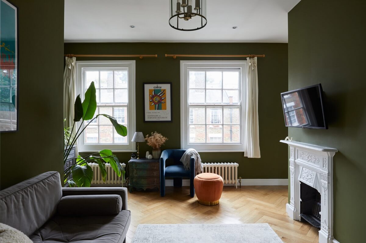 A London Apartment with Olive Green Living Room 2 living-room-olive-green-walls-white-fireplace-dark-gray-sofa-nordroom