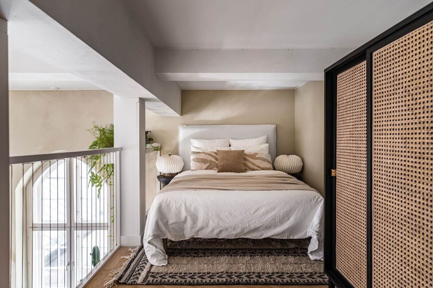 A Historic Factory Transformed Into A Stylish Home 17 loft-bedroom-cane-wardrobe-beige-walls-nordroom