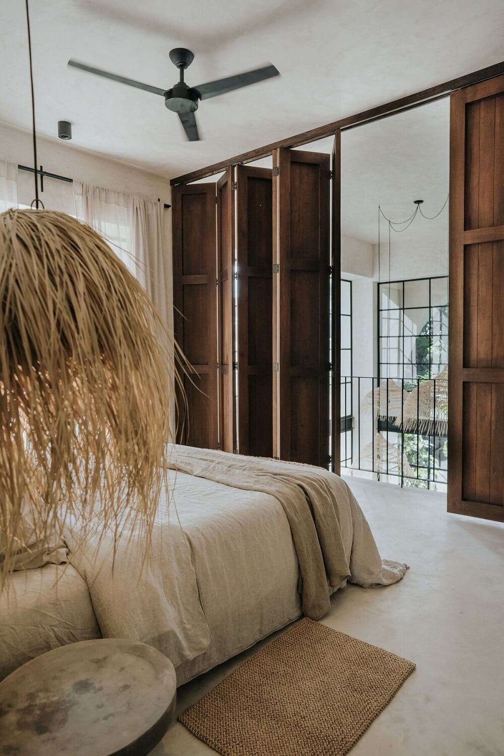A Serene Apartment in Tulum with High Ceilings and Rooftop Pool 15 loft-bedroom-rustic-wooden-harmonica-doors-nordroom