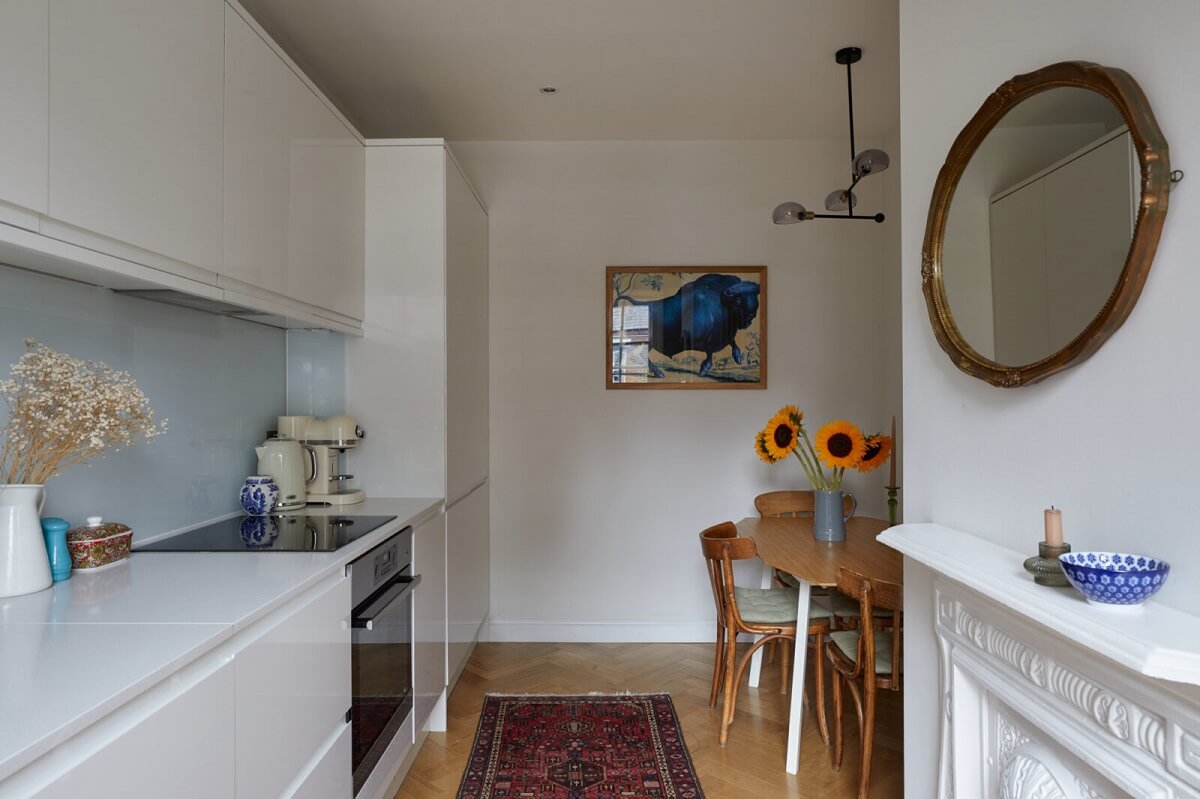 A London Apartment with Olive Green Living Room 8 modern-white-kitchen-dining-space-fireplace-nordroom
