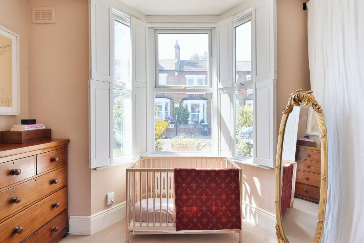 A One-Bedroom Apartment with Colorful Rooms 11 pink-bedroom-crib-bay-window-nordroom