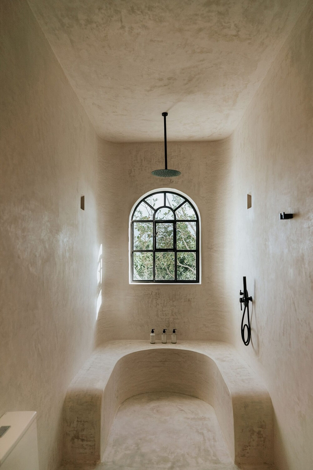 The Top Home Design Trends for 2026: Bold Color, Cozy Corners & Climate-Ready Living 23 shower-bathroom-arched-window-black-fittings-nordroom