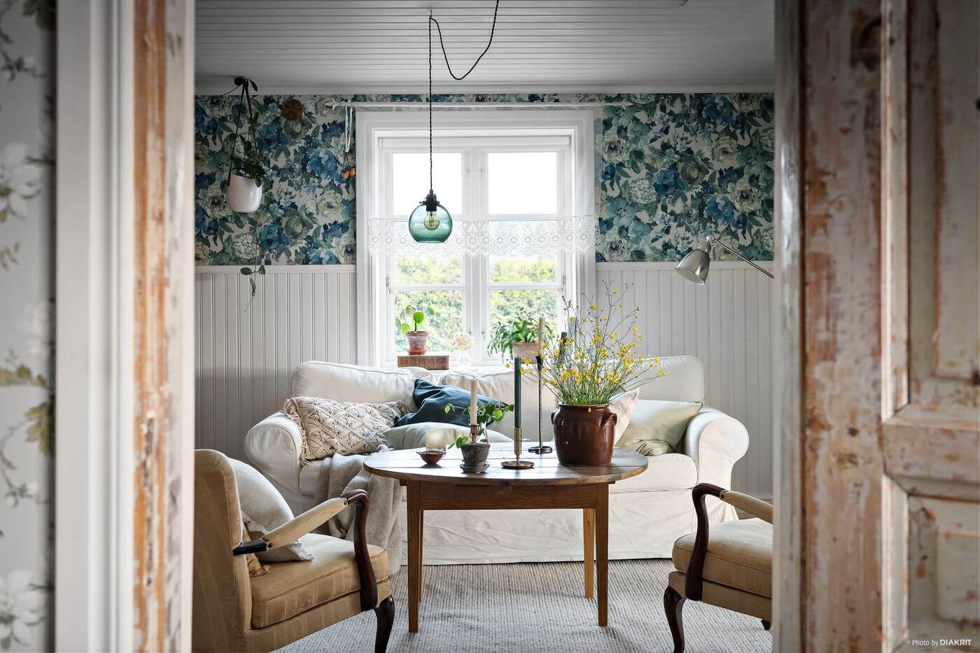 A Charming Swedish Villa Filled with Wallpaper 2 sitting-room-white-ikea-couch-rustic-wooden-doors-nordroom