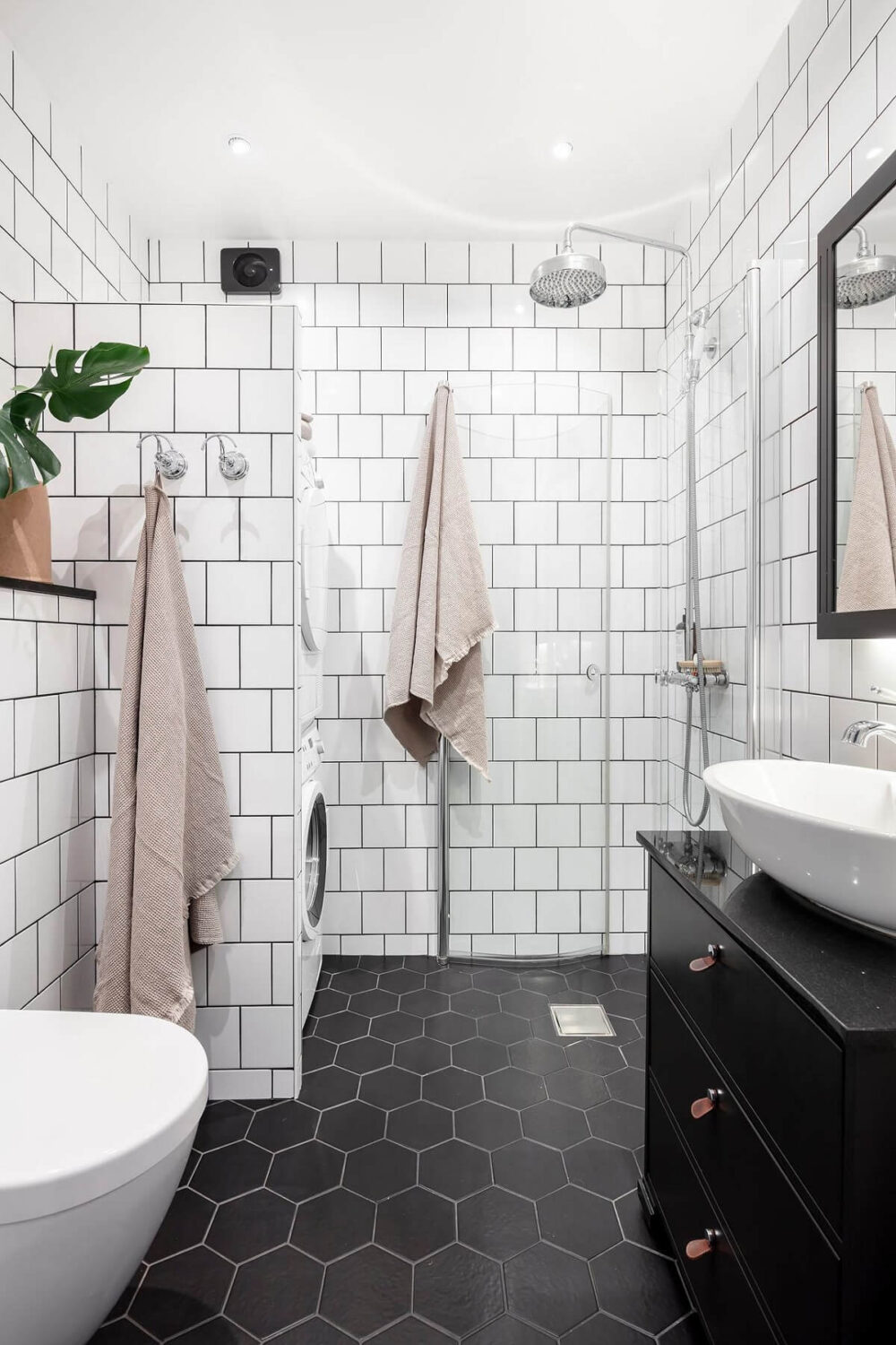 A Swedish Maisonette with Warm Pink Living Room 24 small-bathroom-black-hexagon-floor-tiles-white-wall-tiles-nordroom