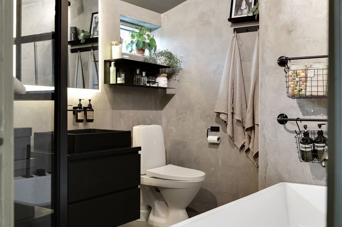 A Swedish 1930s Villa Decorated in Gray and Green Tones 18 small-bathroom-limestone-walls-black-fittings-nordroom