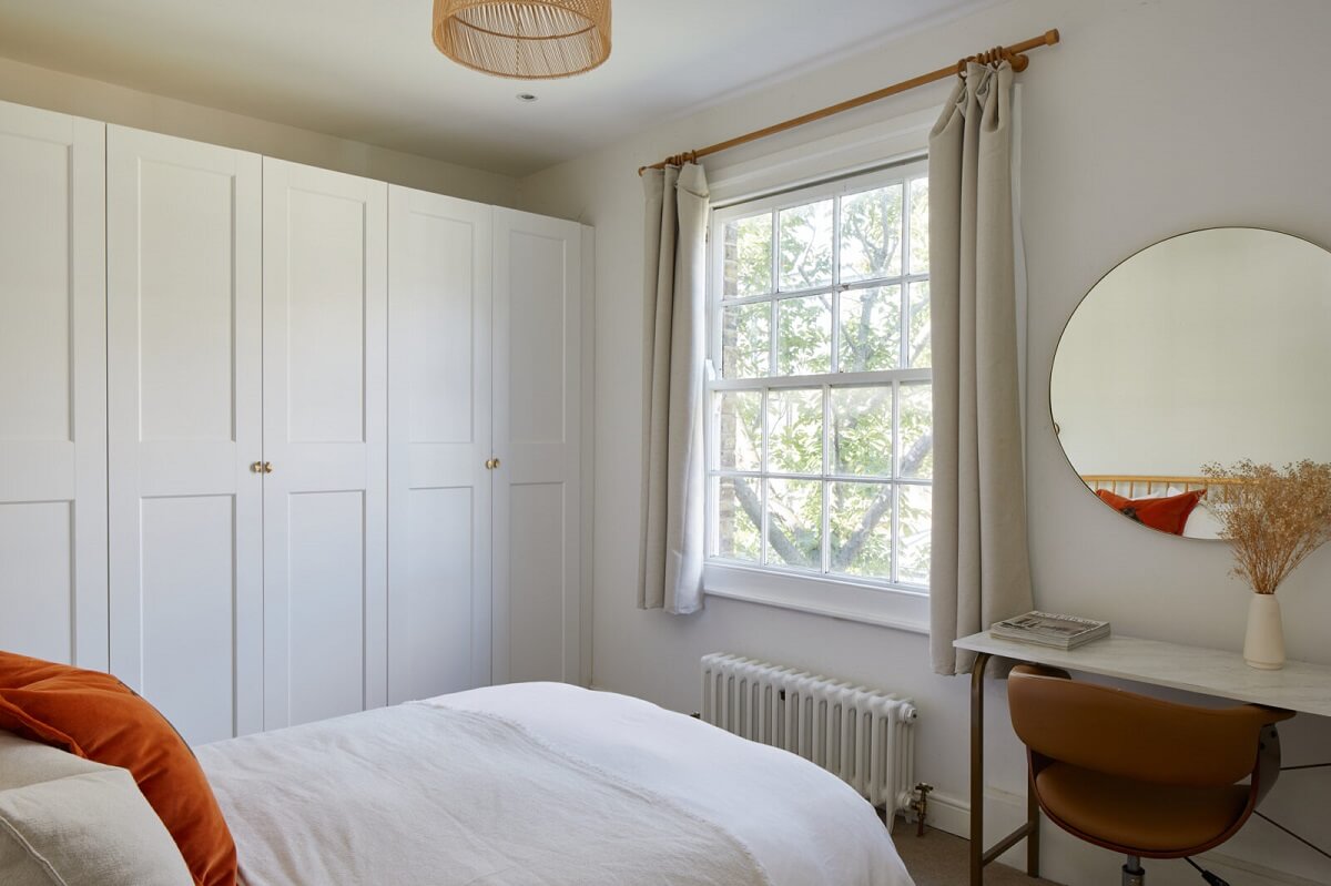 A London Apartment with Olive Green Living Room 11 small-bedroom-built-in-wardrobes-small-desk-round-mirror-norroom