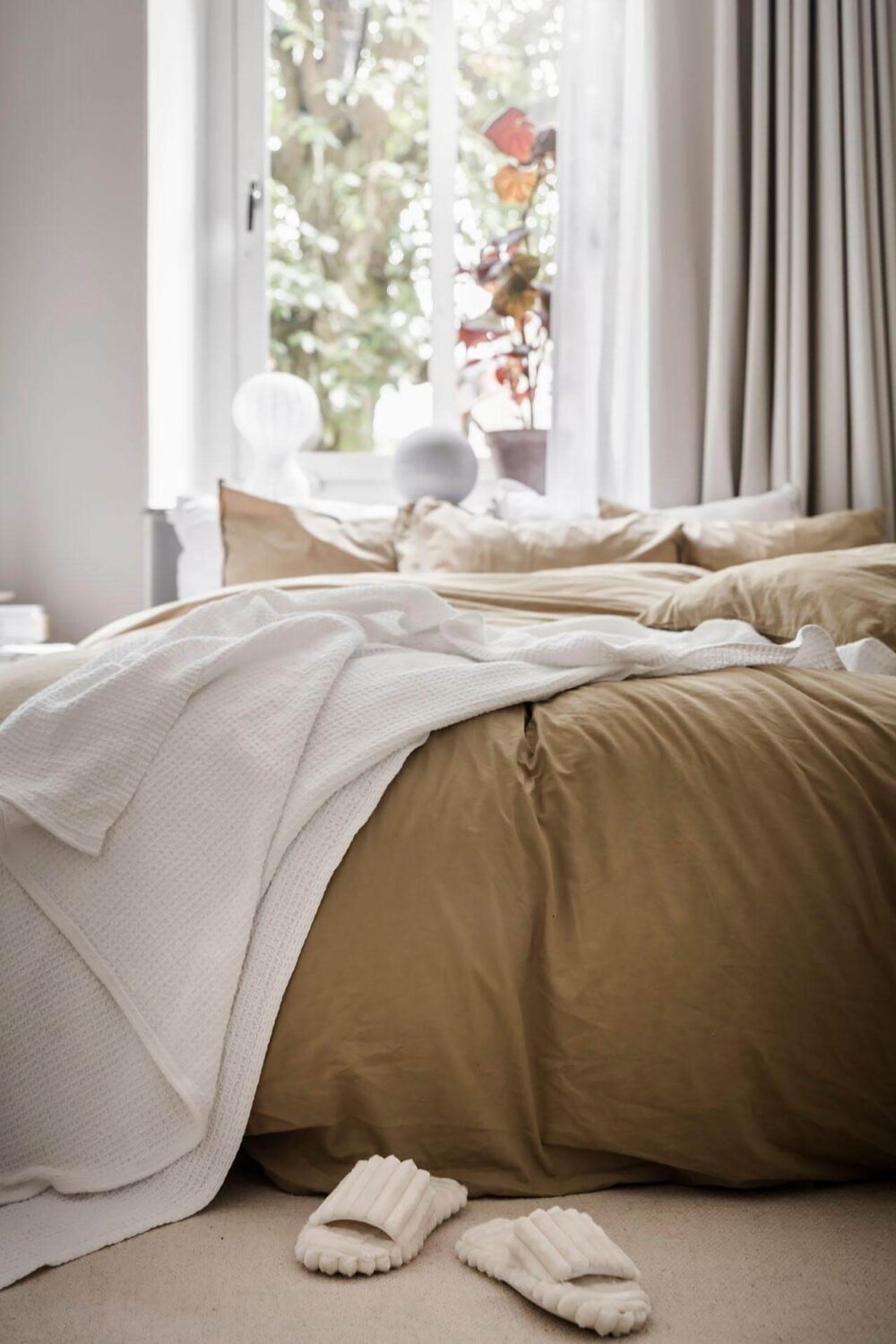 A Tiny and Stylish Nordic Apartment 15 small-bedroom-ochre-yellow-bedding-nordroom