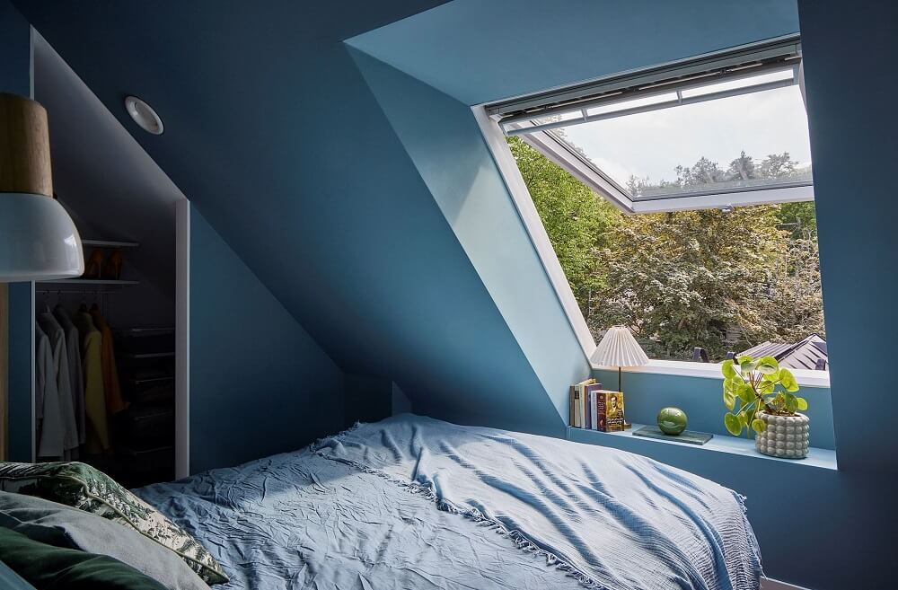 A Split-Level Attic Apartment with Blue Bedroom 12 small-blue-attic-apartment-closet-window-nordroom