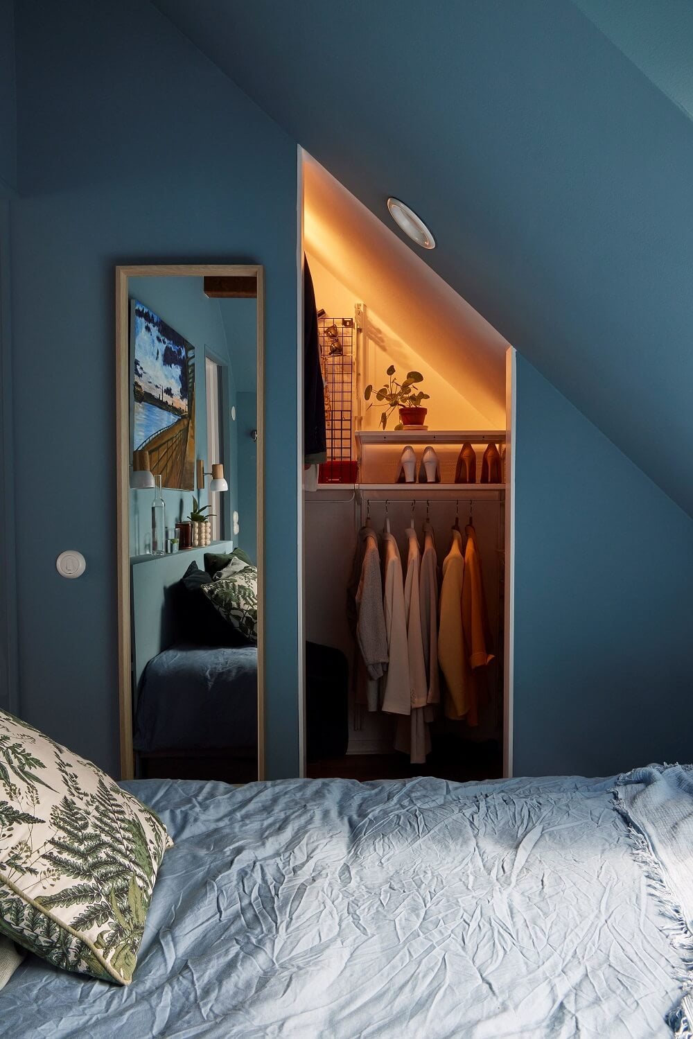 A Split-Level Attic Apartment with Blue Bedroom 13 small-blue-attic-bedroom-walk-in-closet-nordroom