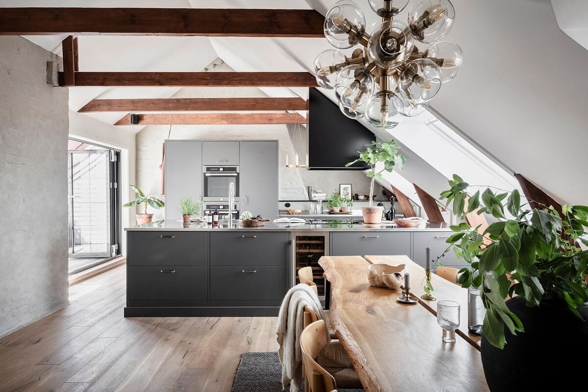 A Swedish Maisonette with Warm Pink Living Room 1 social-kitchen-space-slanted-ceiling-stainless-steel-nordroom
