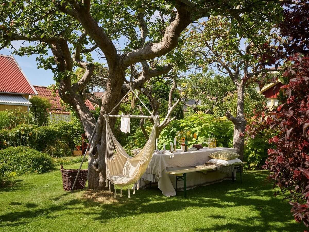 Best of 2022: Outdoor Spaces 5 swedish-summerhouse-garden-hanging-chair-dining-area-nordroom