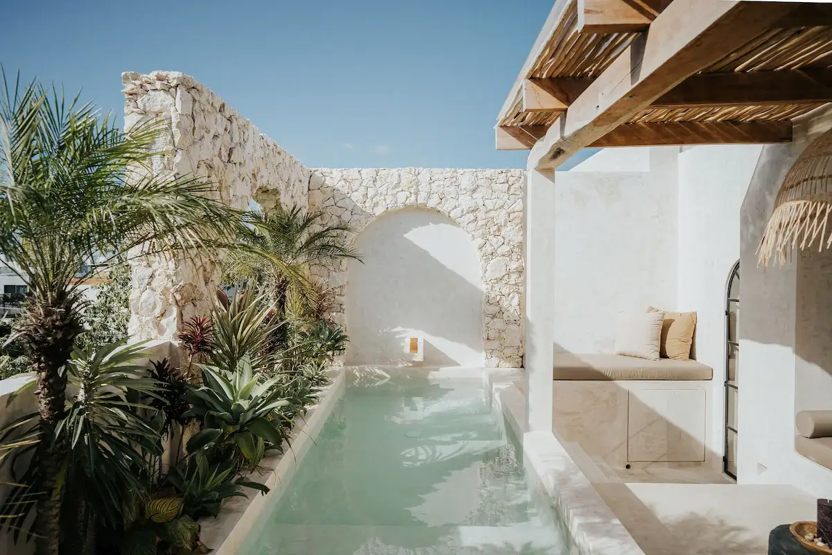 A Serene Apartment in Tulum with High Ceilings and Rooftop Pool 29 swimming-pool-stone-wall-lounge-airbnb-nordroom