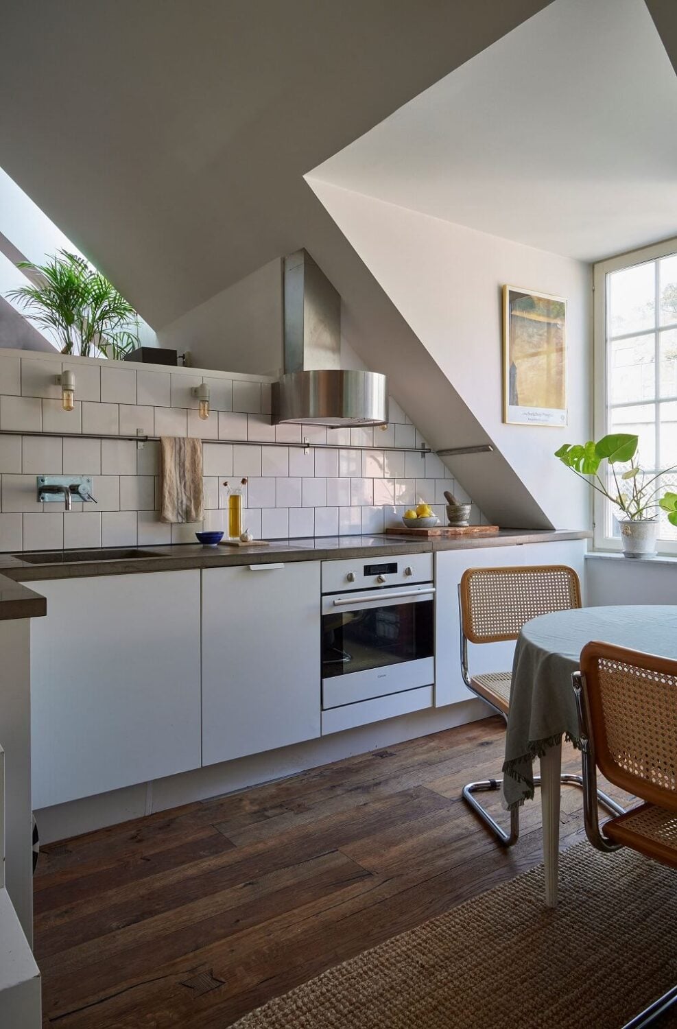 A Split-Level Attic Apartment with Blue Bedroom 5 white-kitchen-sloped-ceiling-attic-apartment-nordroom