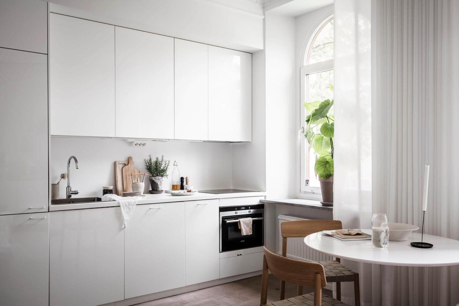 A Tiny and Stylish Nordic Apartment 13 white-minimalistic-kitchen-cabinets-nordroom