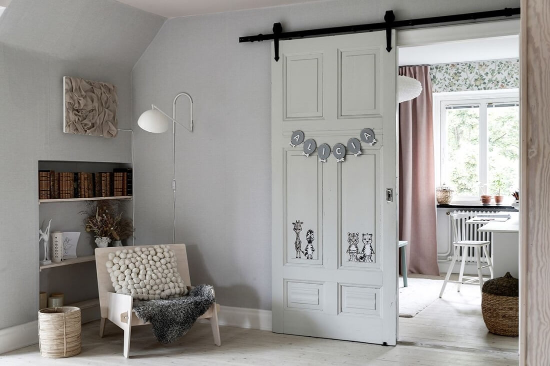 A Swedish 1930s Villa Decorated in Gray and Green Tones 16 white-painted-barn-door-nordroom