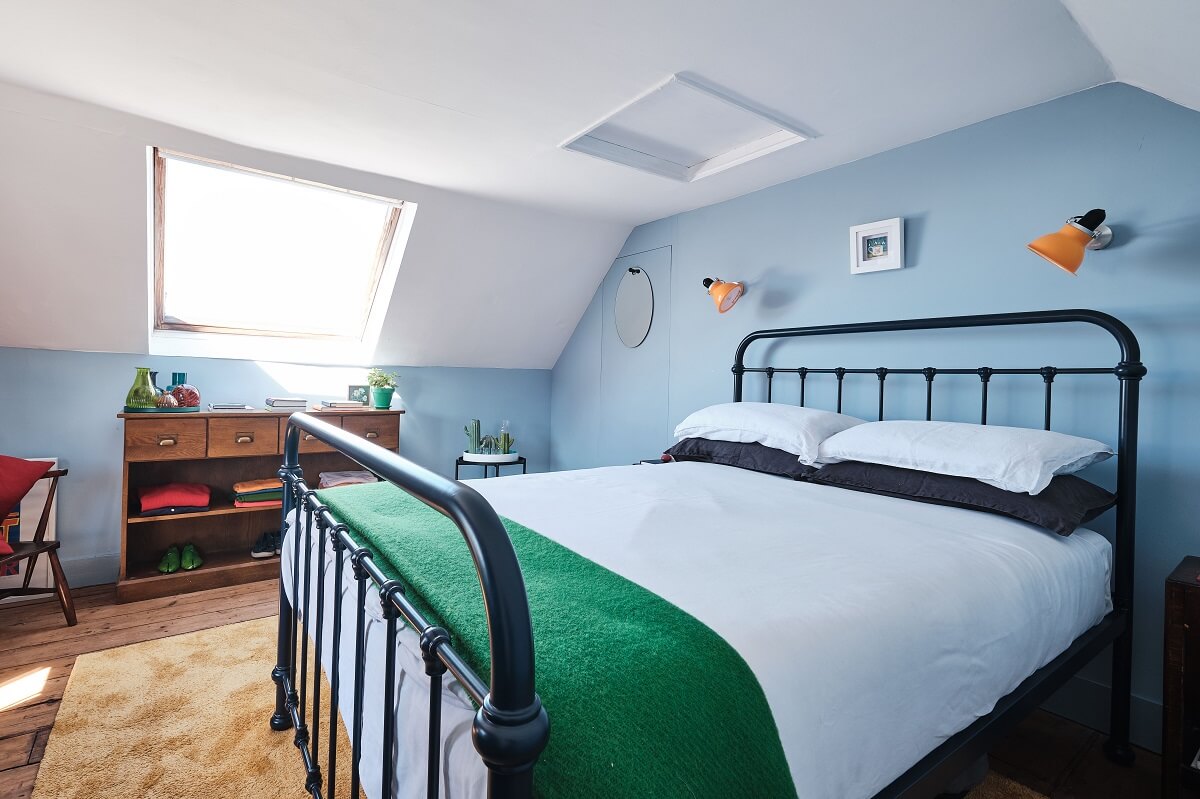 Bold Colors in a Charming English Cottage 15 baby-blue-cottage-bedroom-sloped-ceiling-nordroom