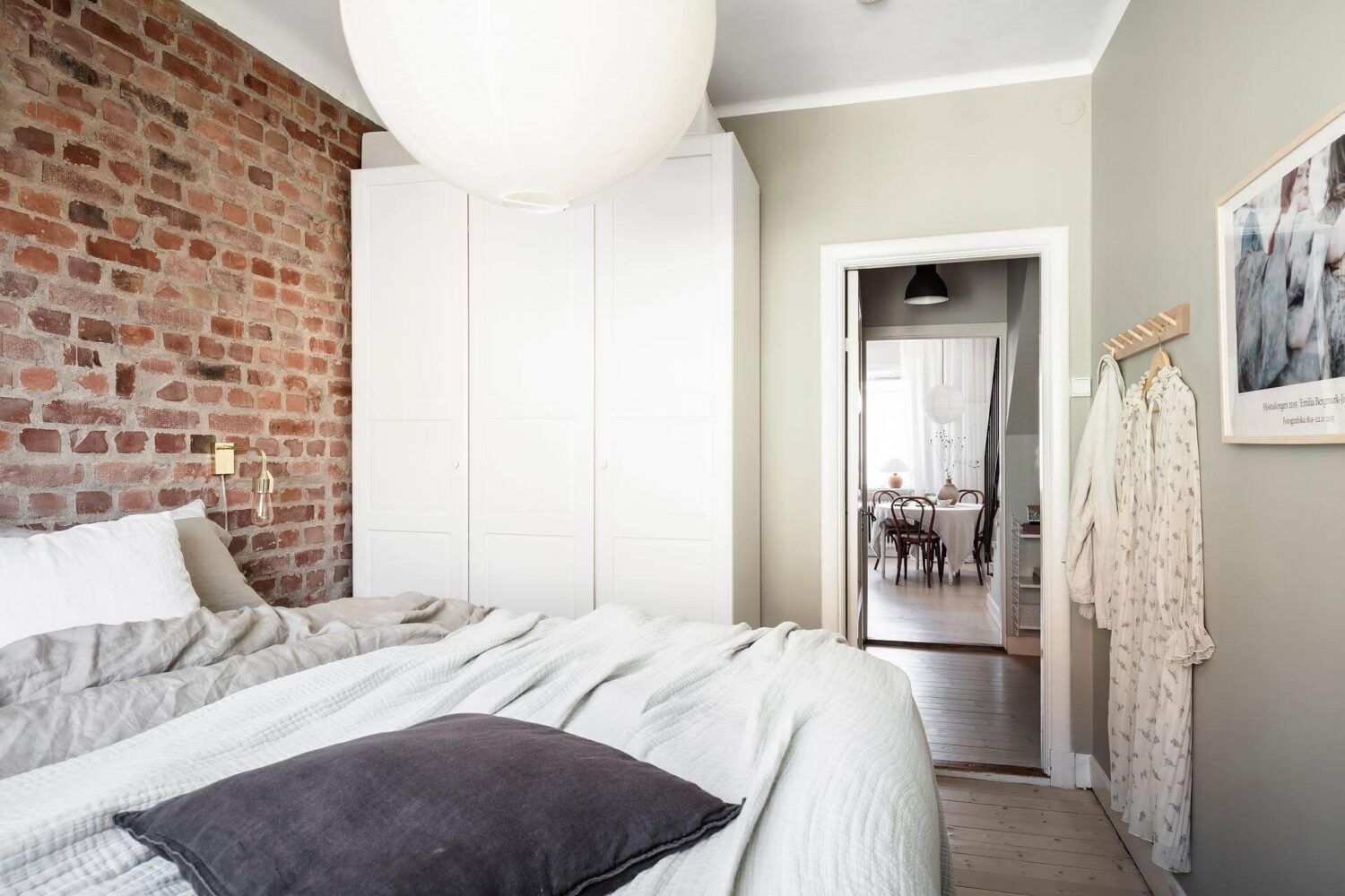 A Living Room with Pink Accents in a Light Attic Apartment 18 bedroom-exposed-brick-wall-nordic-maisonette-nordroom