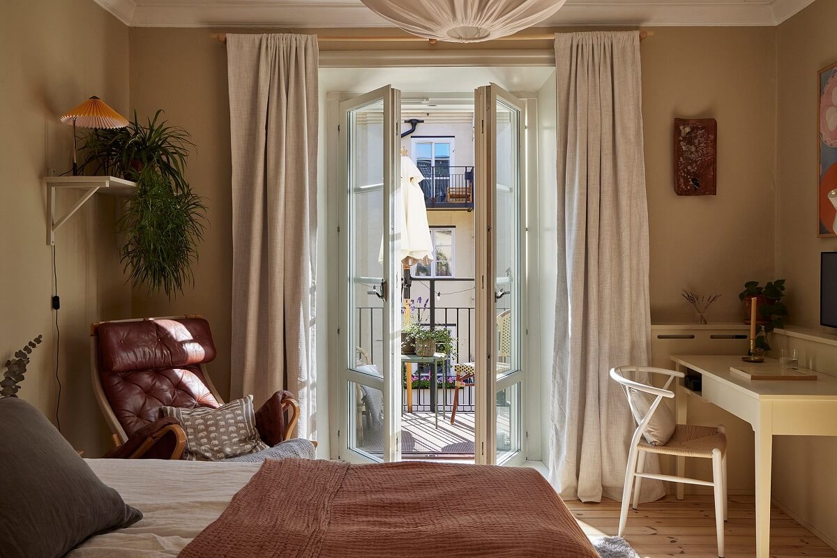 A Small Nordic Home Decorated in Warm Light Colors 11 bedroom-home-office-balcony-warm-beige-green-walls-nordroom