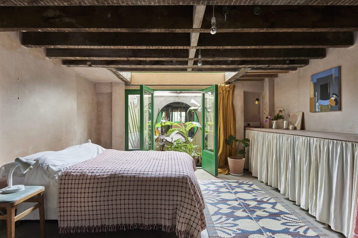 A Unique Home in a Former Furniture Workshop 12 bedroom-low-ceiling-exposed-wooden-beams-patio-nordroom