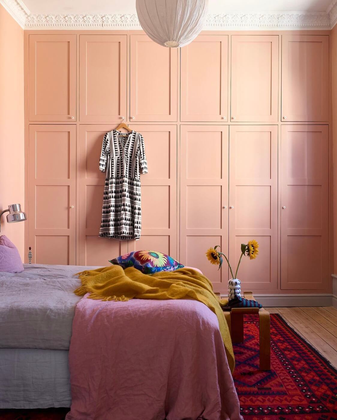 A Swedish Family Home Packed With Color 7 bedroom-pink-built-in-wardrobes-dark-pink-rug-nordroom