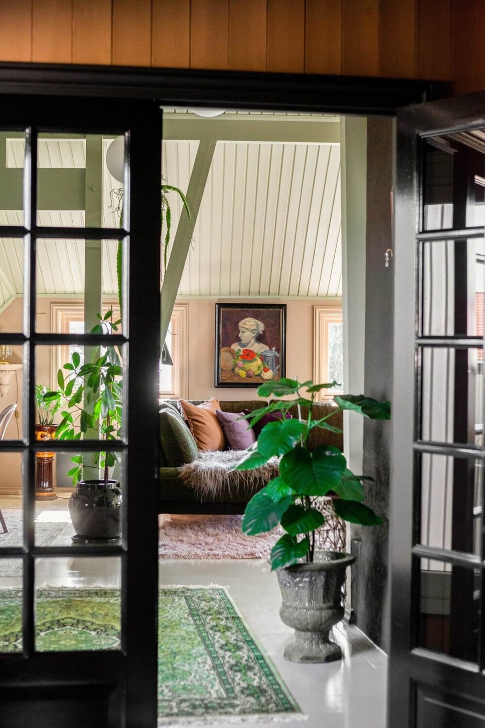 A Charming Attic Apartment Decorated with Color 19 black-double-glass-doors-green-rug-nordroom