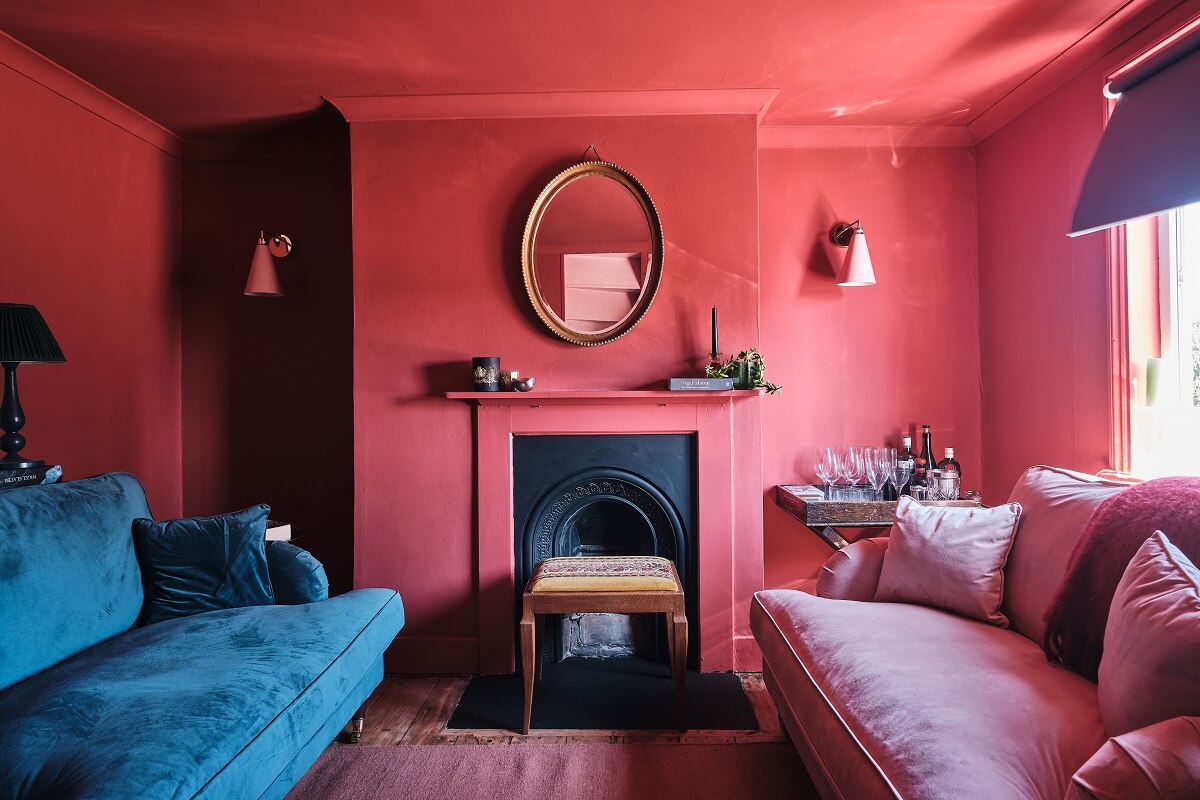 Bold Colors in a Charming English Cottage 13 blue-pink-sofa-pink-sitting-room-fireplace-english-cottage-nordroom