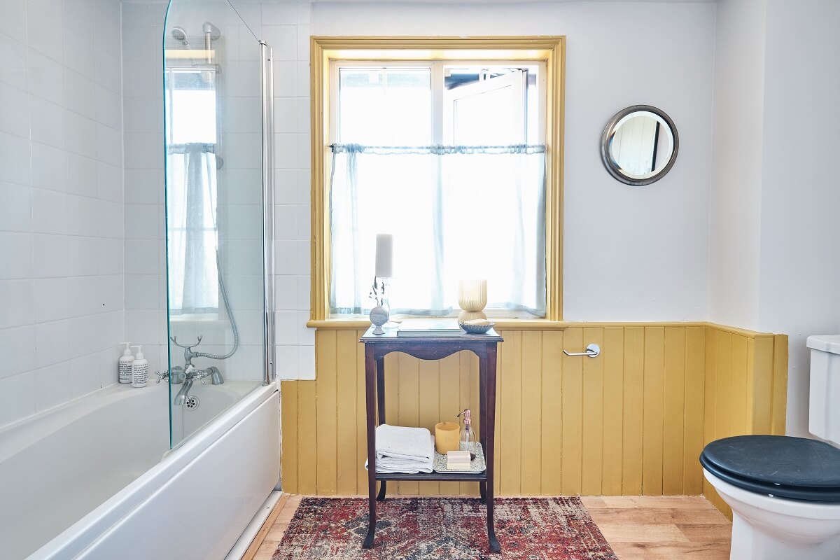 Bold Colors in a Charming English Cottage 18 cottage-bathroom-yellow-woodpaneling-nordroom