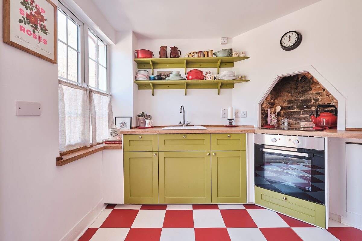 Bold Colors in a Charming English Cottage 7 cottage-kitchen-green-cabinets-checkerboard-floor-nordroom