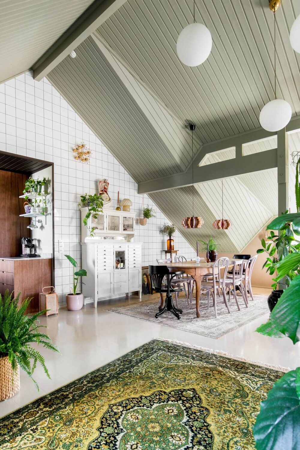 A Charming Attic Apartment Decorated with Color 12 dining-space-slanted-ceiling-tiled-wall-nordroom