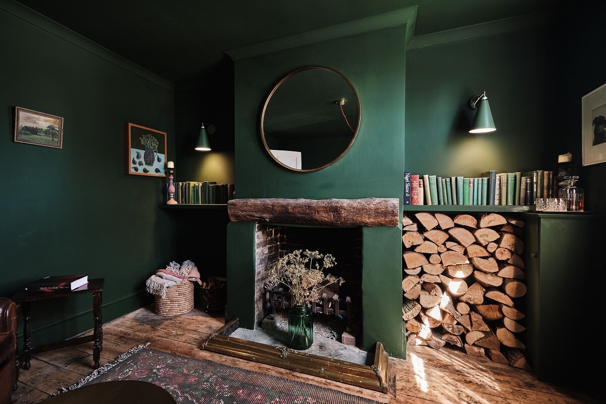 Bold Colors in a Charming English Cottage 3 english-cottage-moody-dark-green-sitting-room-fireplace-round-mirror-nordroom