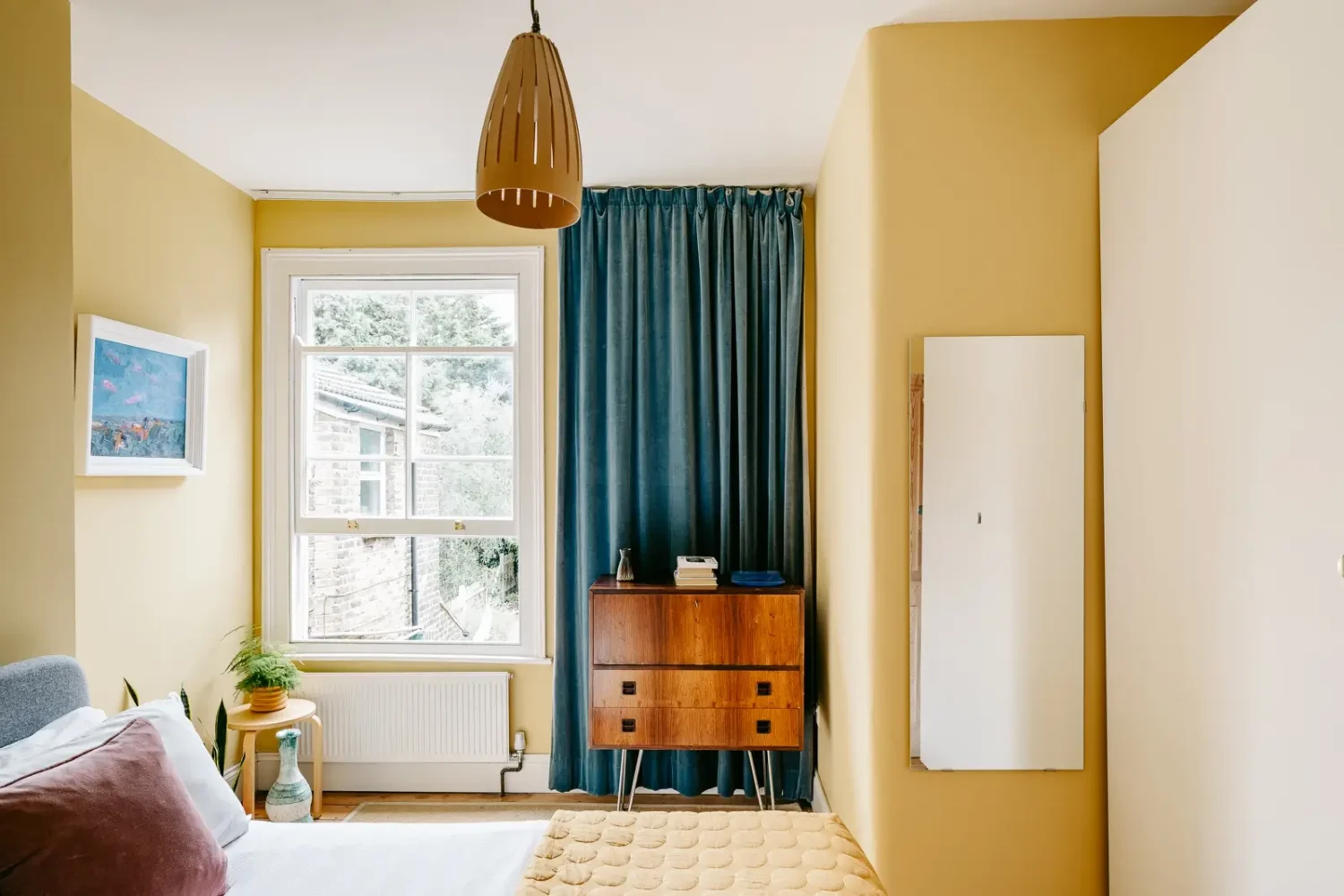 A London Home with Modern Extension and Color Accents 12 farrow-ball-yellow-groud-wall-color-bedroom-blue-curtains-nordroom