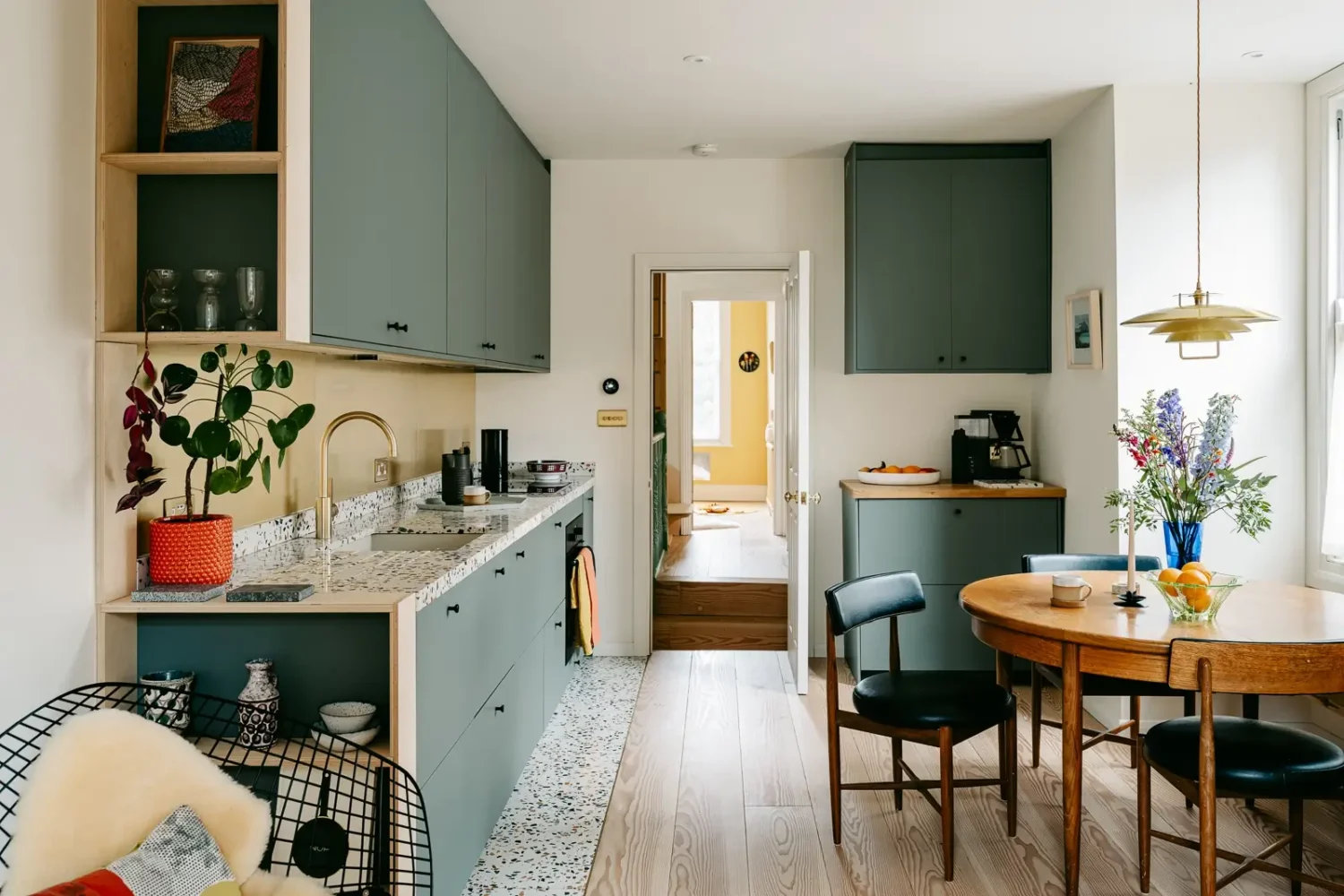 A London Home with Modern Extension and Color Accents 4 green-kitchen-cabinets-terrazzo-worktops-tiles-round-dining-table-nordroom