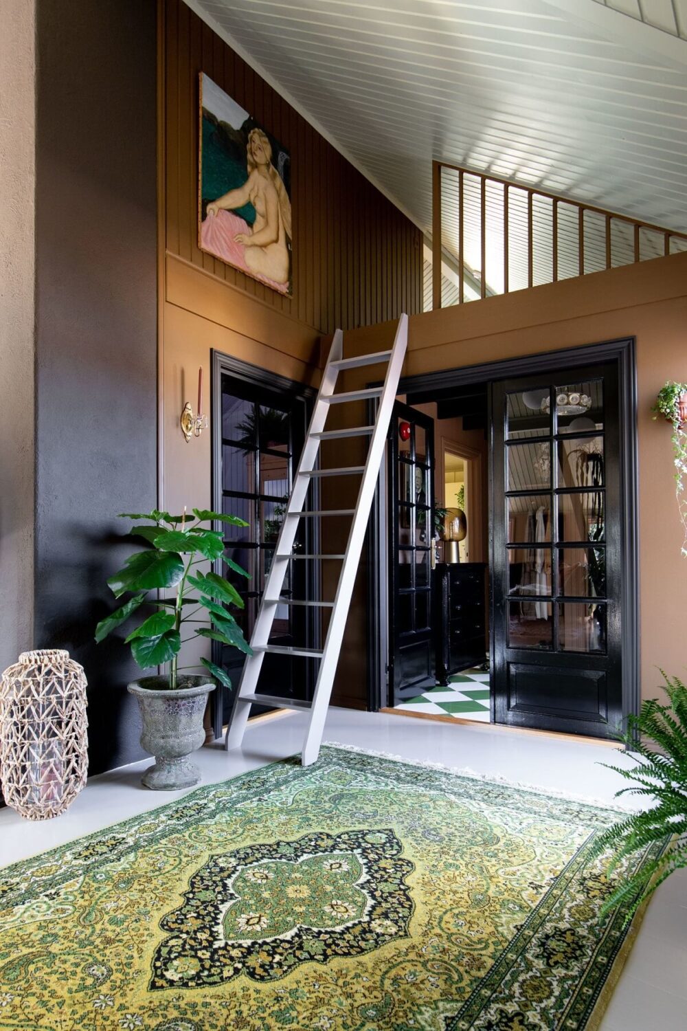 A Charming Attic Apartment Decorated with Color 16 hallway-loft-space-black-doors-green-rug-nordroom