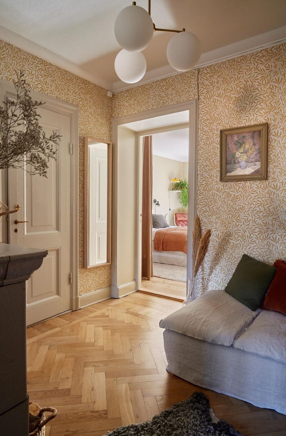 A Small Nordic Home Decorated in Warm Light Colors 9 hallway-sitting-area-fireplace-william-morris-willow-wallpaper-nordroom