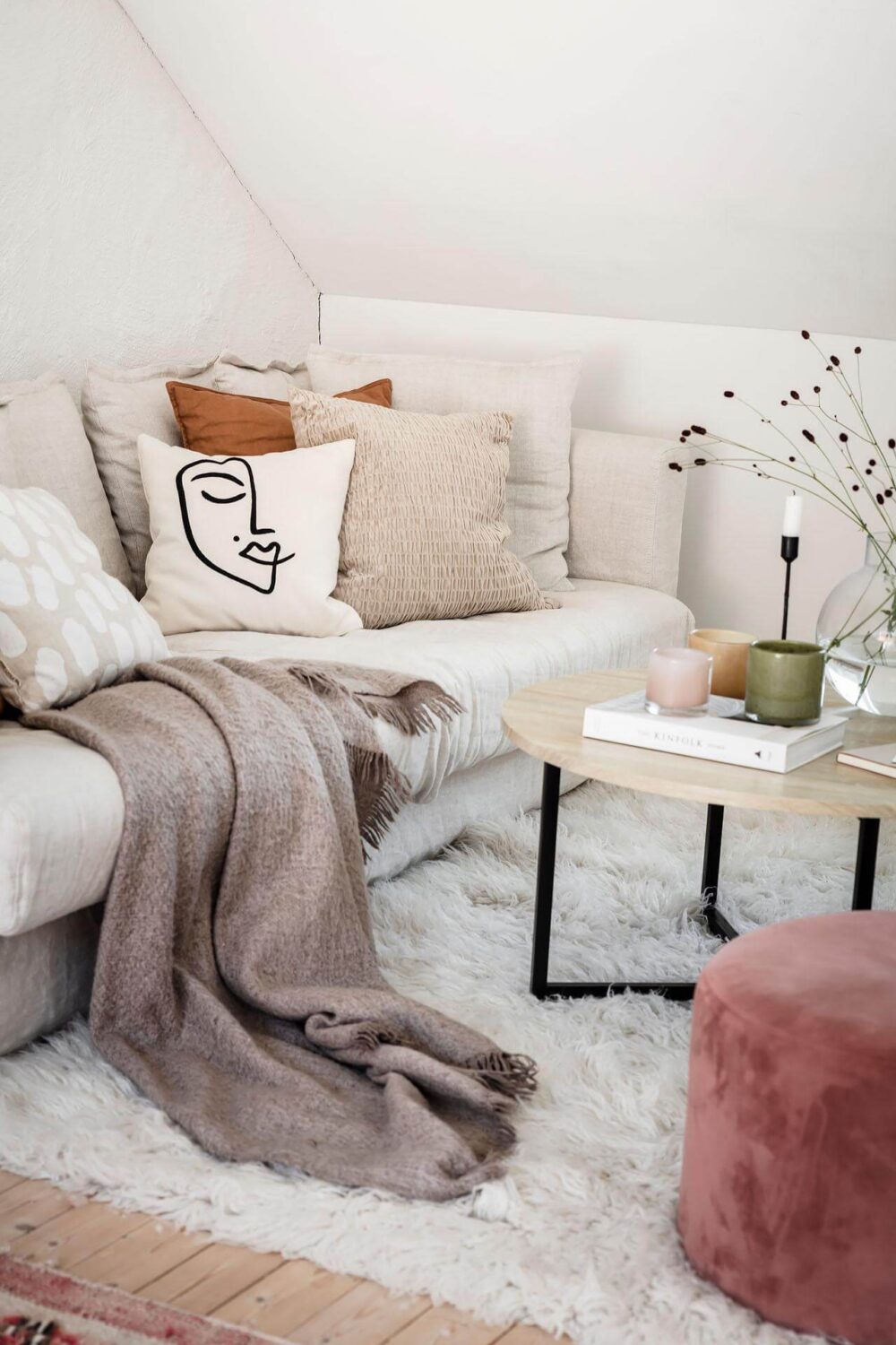 A Living Room with Pink Accents in a Light Attic Apartment 3 living-room-detail-pink-ottoman-nordroom